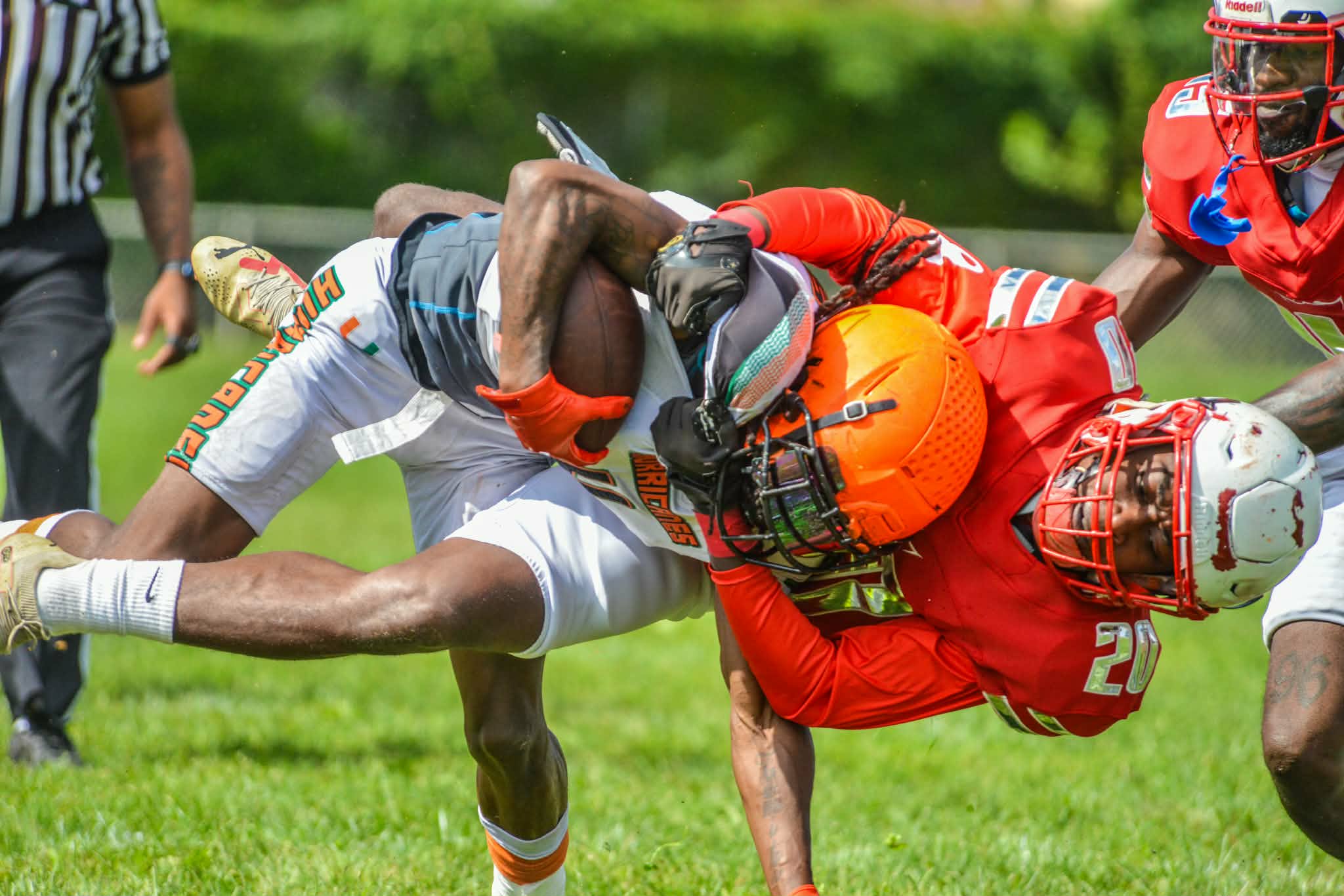 Two football players collide during a tackle